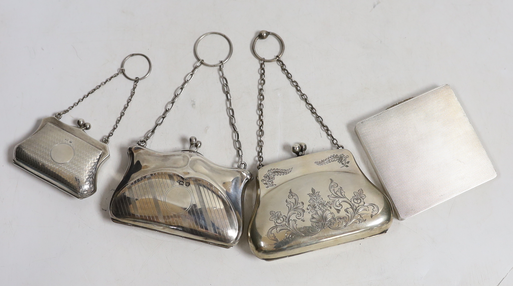 A late Victorian silver handbag purse with suspension chain, Birmingham, 1898, two later silver hand bag purses and a modern engine turned silver compact.